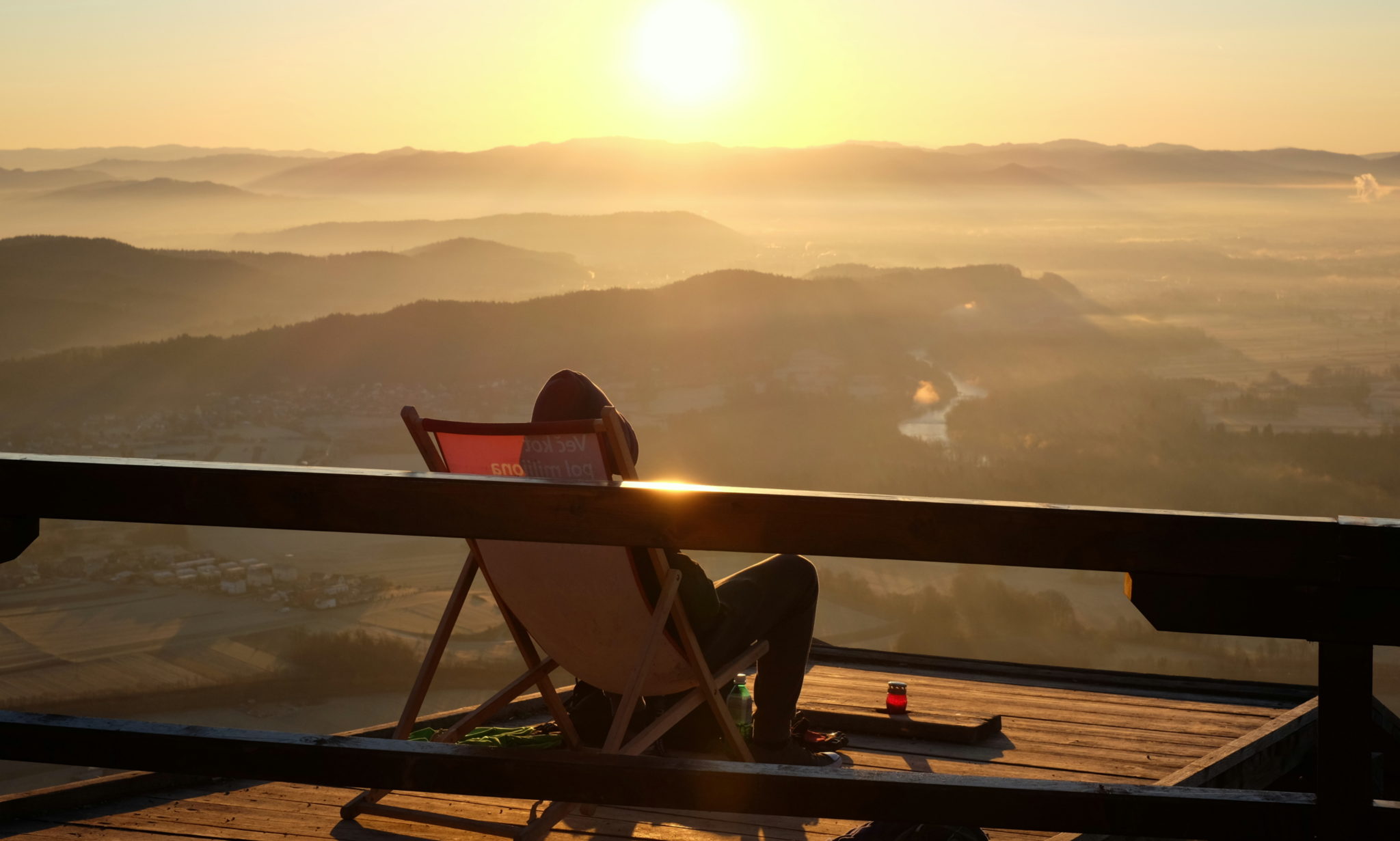 Resting in a simple wooden recliner wile enjoying the sunrise.