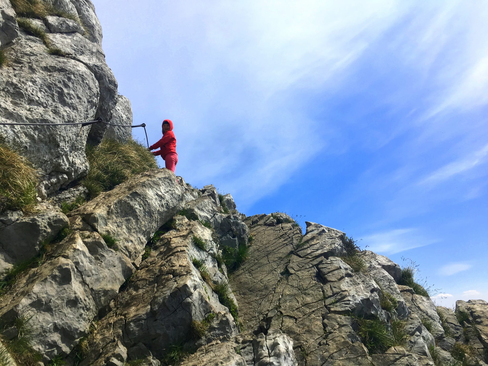 A little girl climbing a mountain