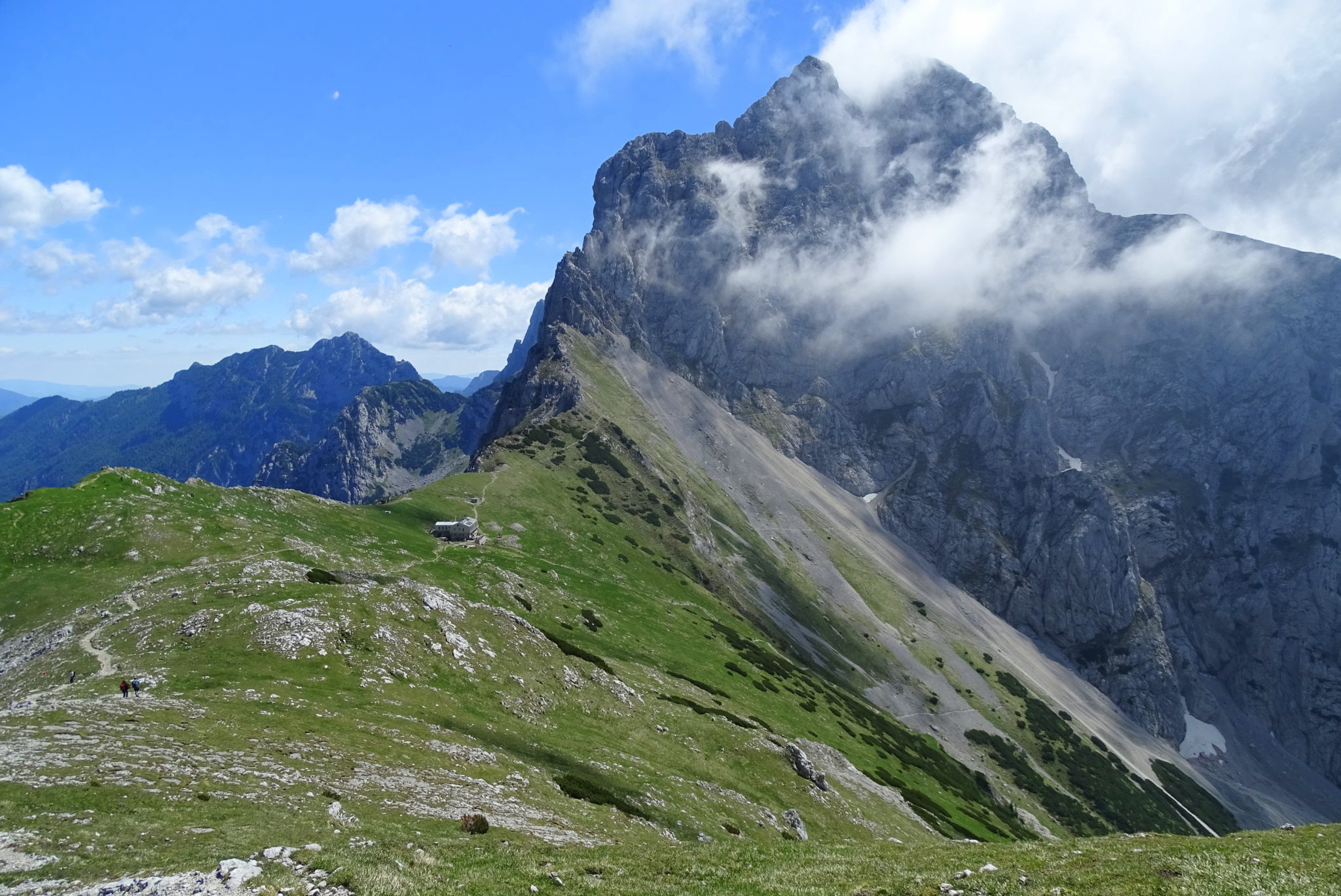 An Alpine meadow nested among high mountains