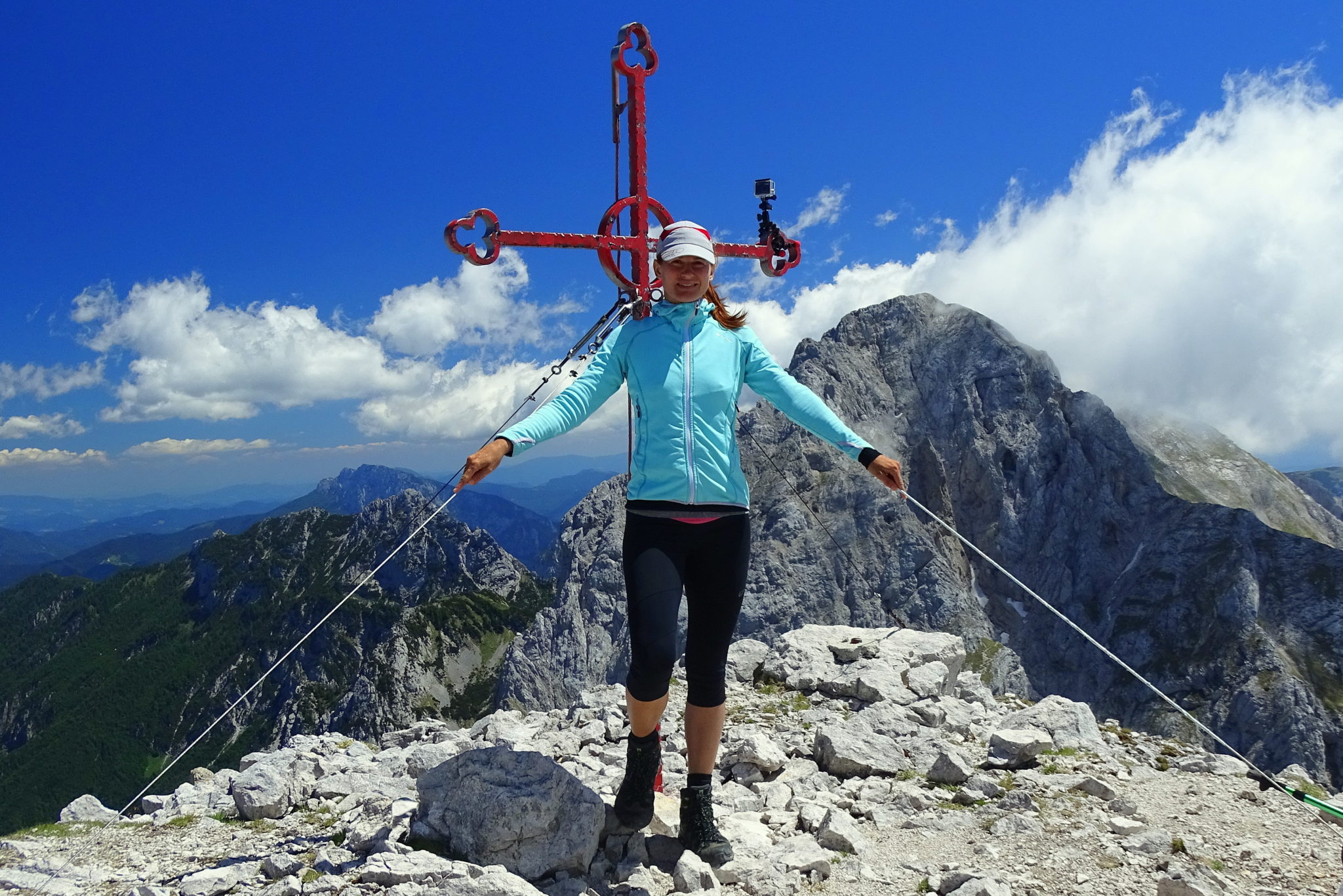A woman hiker at the top of Mount Brana above Kamniško Sedlo, Slovenia