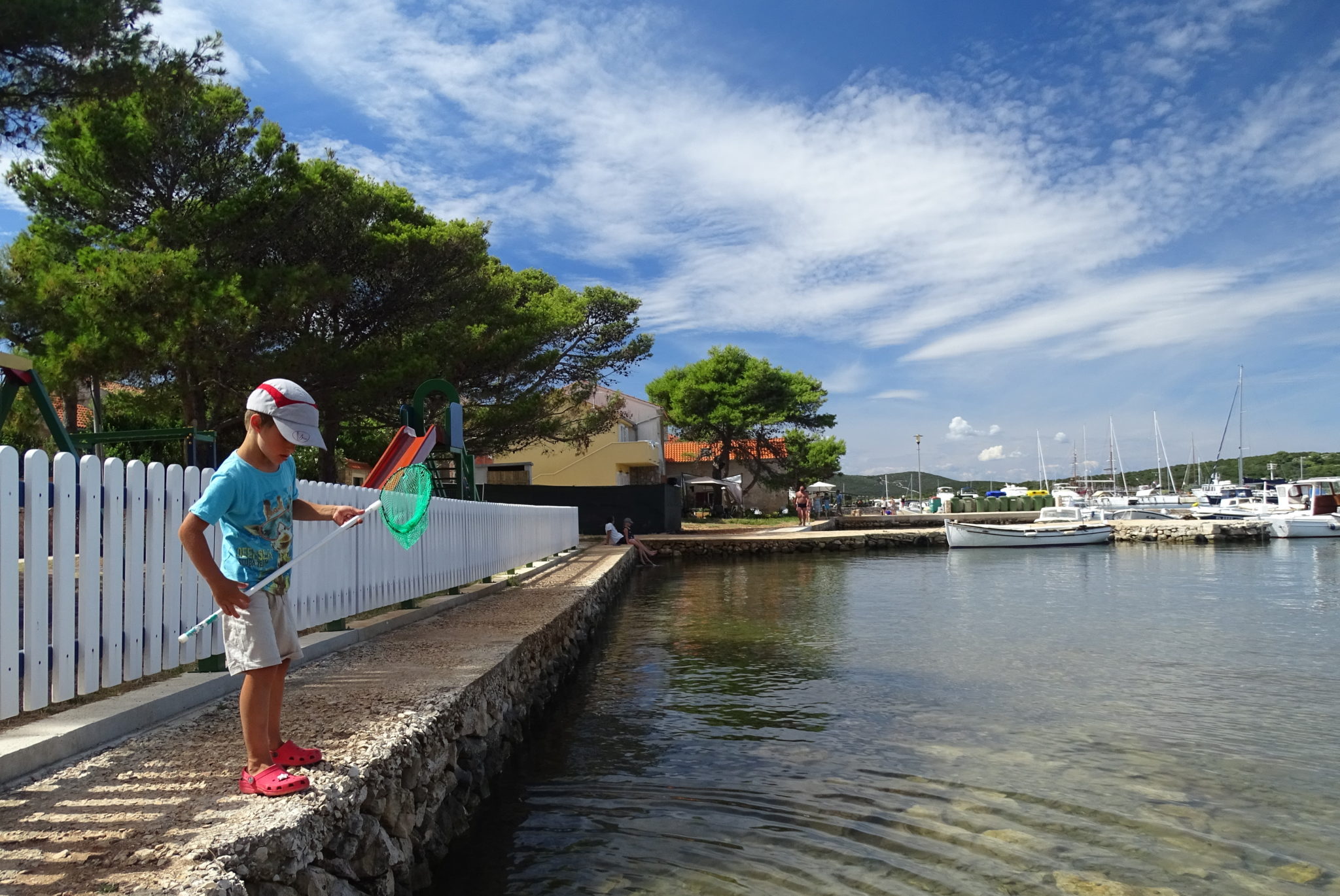 A kid catching crabs in the Ilovik village