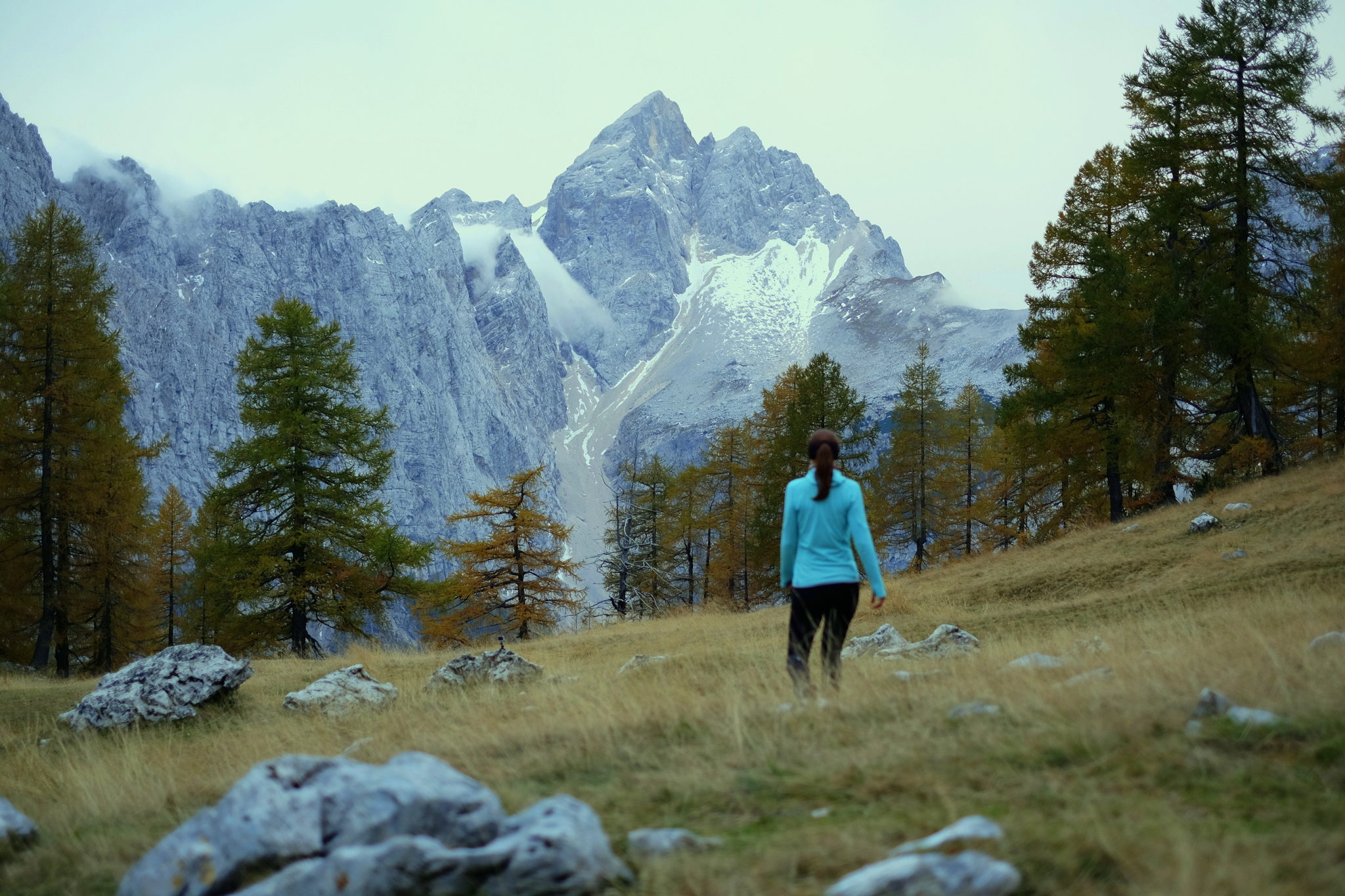 A female hiker looking Jalovec from Sleme, above Kranjska Gora, Slovenia