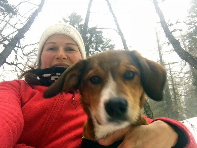 a female hiker and a dog