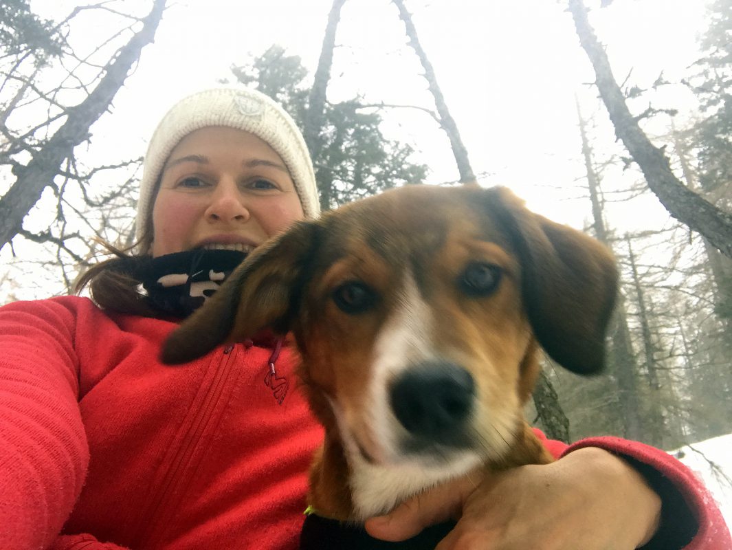 a female hiker and a dog