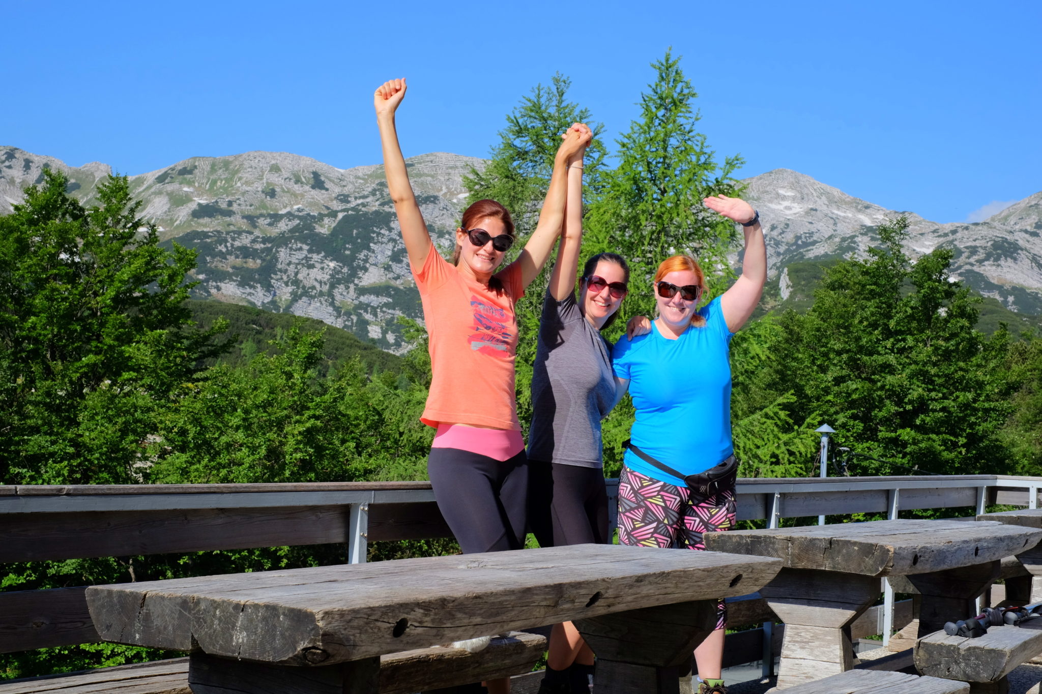 Three women hikers happy at the Komna hut, Julian Alps, Slovenia