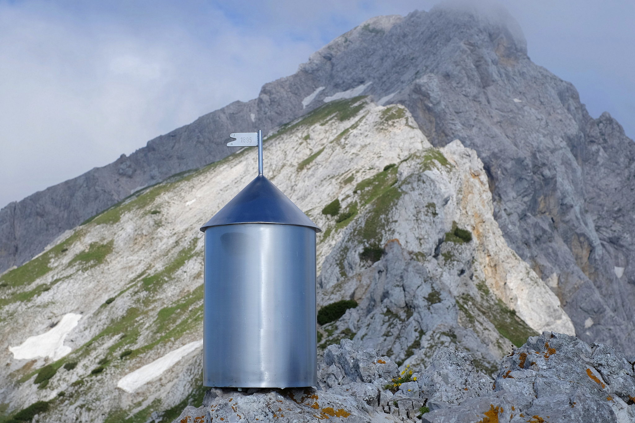 While one of the few miniature Aljaž Towers in the Slovenian Alps decorates the top of Mala Ojstrica underneath Ojstrica, the real thing sits at the rooftop of Slovenia, Mt. Triglav.